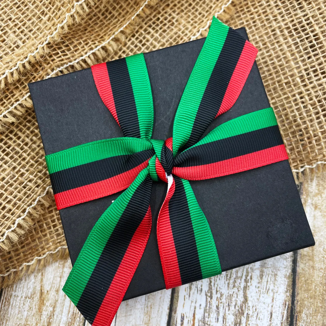 Pan African flag ribbon stripes of black red and green printed on 7/8" white grosgrain